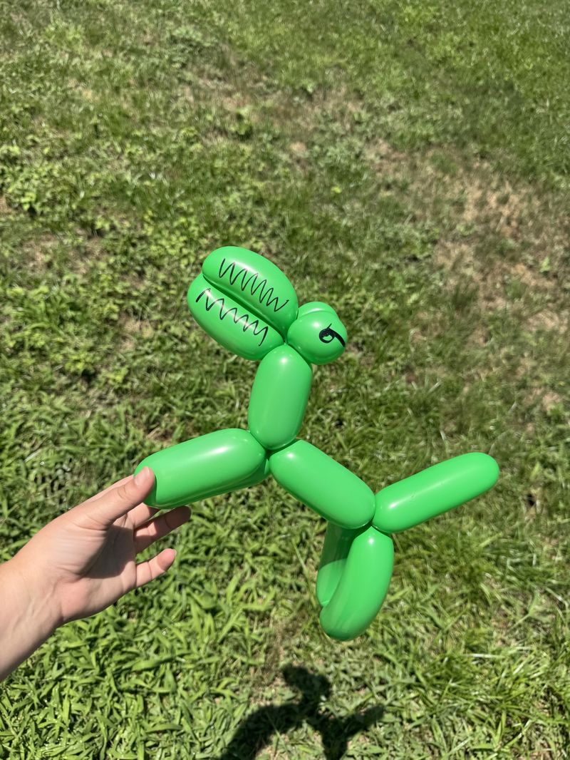 Green balloon dinosaur for kids party entertainment in Texas