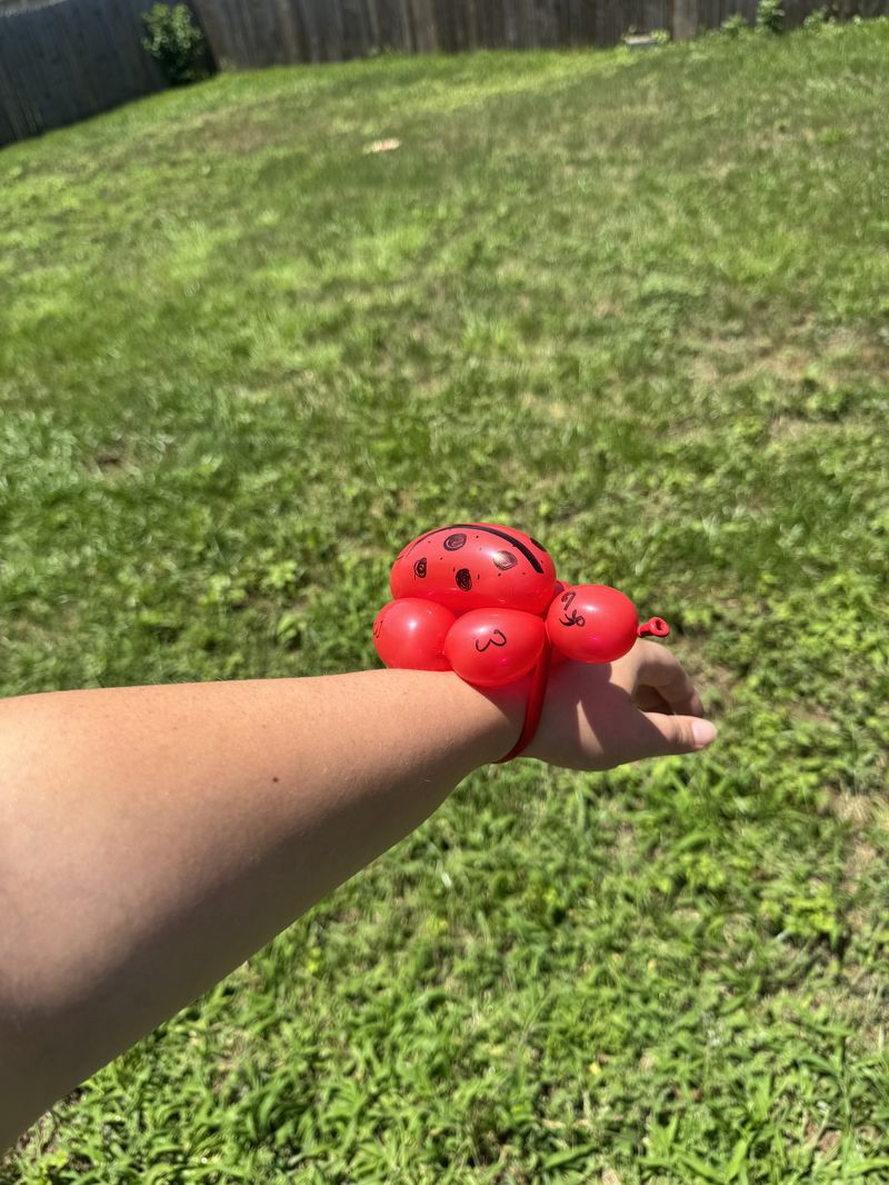 Balloon ladybug wrist bracelet at a kids party in Texas