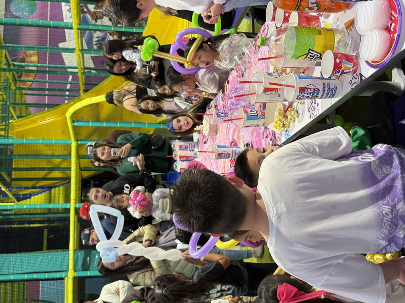 Balloon twisting at an indoor playground birthday party in Texas