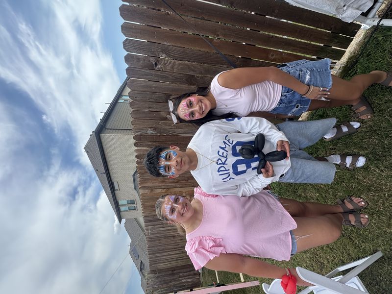 Outdoor face painting for teens at a Texas party