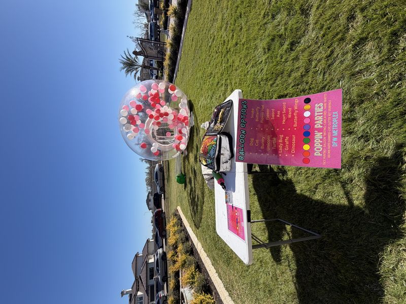 Poppin Parties balloon twisting setup table at a DFW Texas event